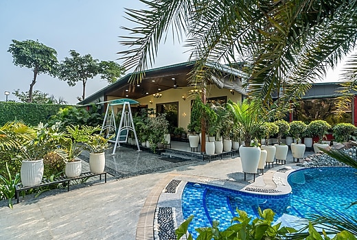 ELIVAAS Leo's Den 4 BHK Farmhouse With Pvt Pool & Cricket Pitch